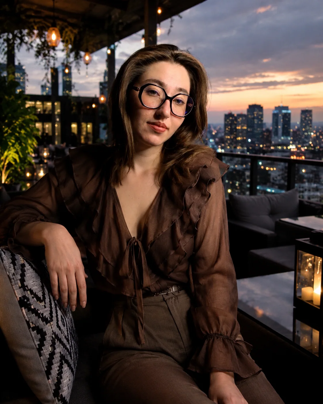 Yaroslavna in a brown editorial look overlooking the city at dusk